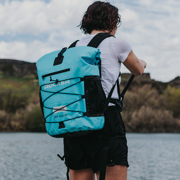 Person paddling with the irocker backpack cooler Bundle