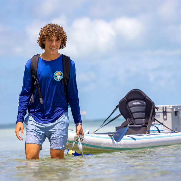 Young man standing in front of his SUP converted to a Kayak and smiling  Bundle